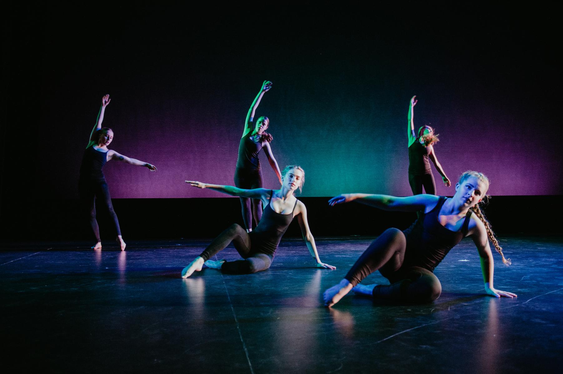a group of dance students performing on a stage